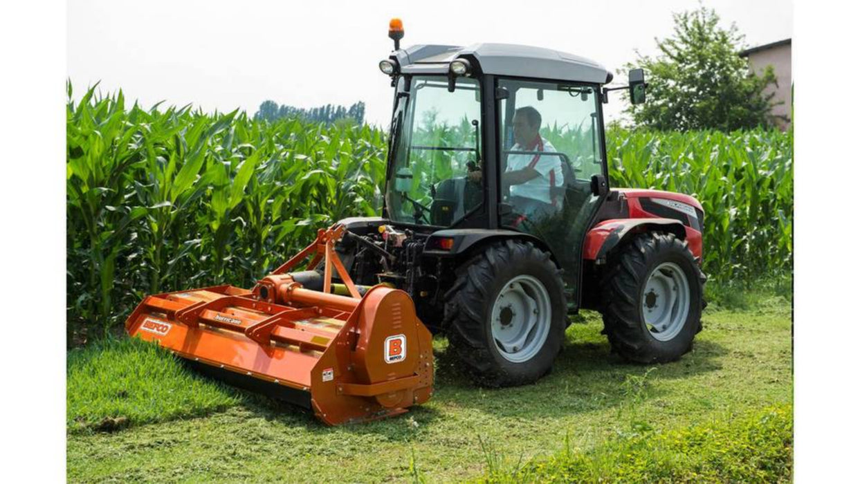 Tractor operating a BEFCO Hurricane H70 flail mower beside a cornfield