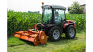 Tractor operating a BEFCO Hurricane H70 flail mower beside a cornfield